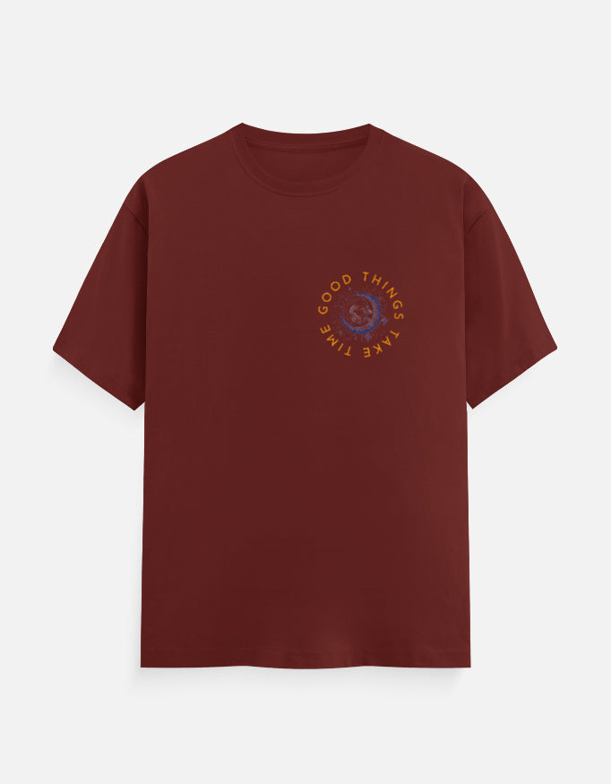Maroon t-shirt with a circular graphic print reading Good Things Take Time