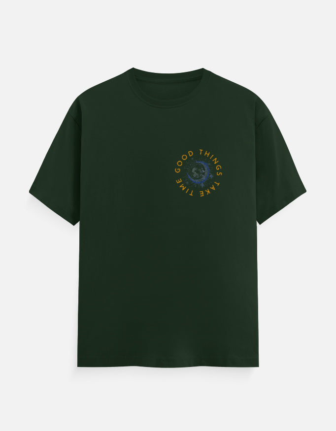 Dark green cotton t-shirt featuring a circular graphic print with the text Good Things Take Time.